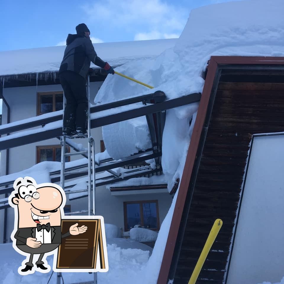 Bachrain – Golling an der Salzach in Austria - a man standing on a ladder in the snow.