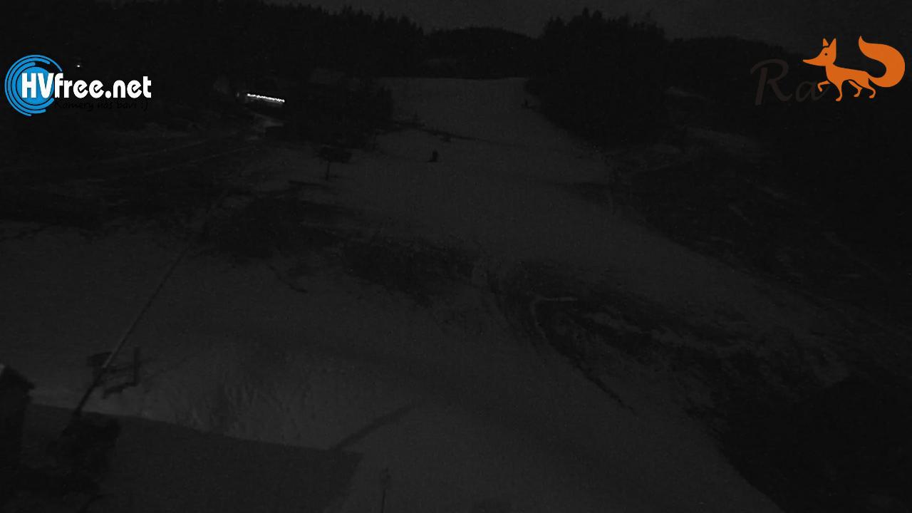 Soláň – Bzové in Czech Republic - an aerial view of a green field with a small house in the background.