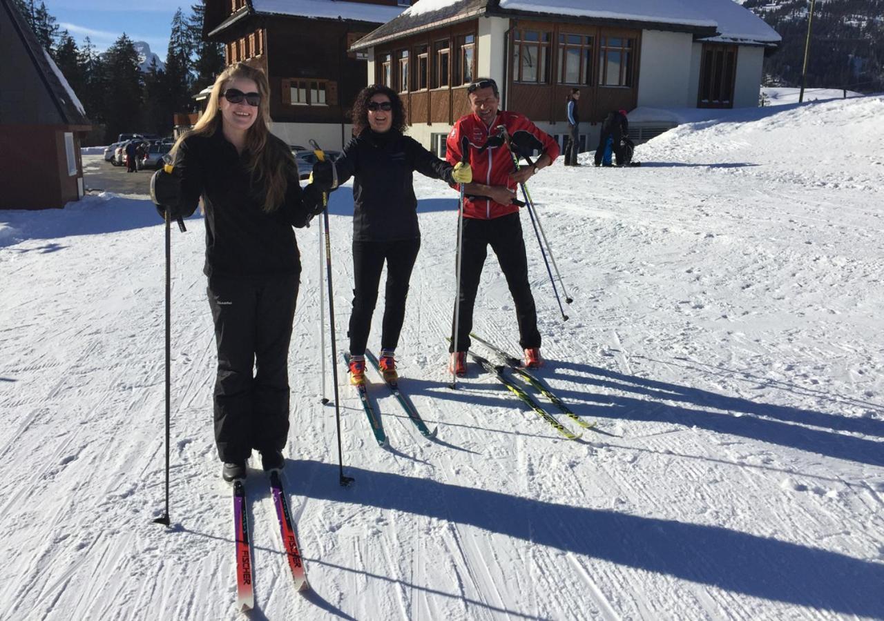 Bergbahnen Sörenberg AG in Switzerland - a group of people riding ski boards on a snowy slope.