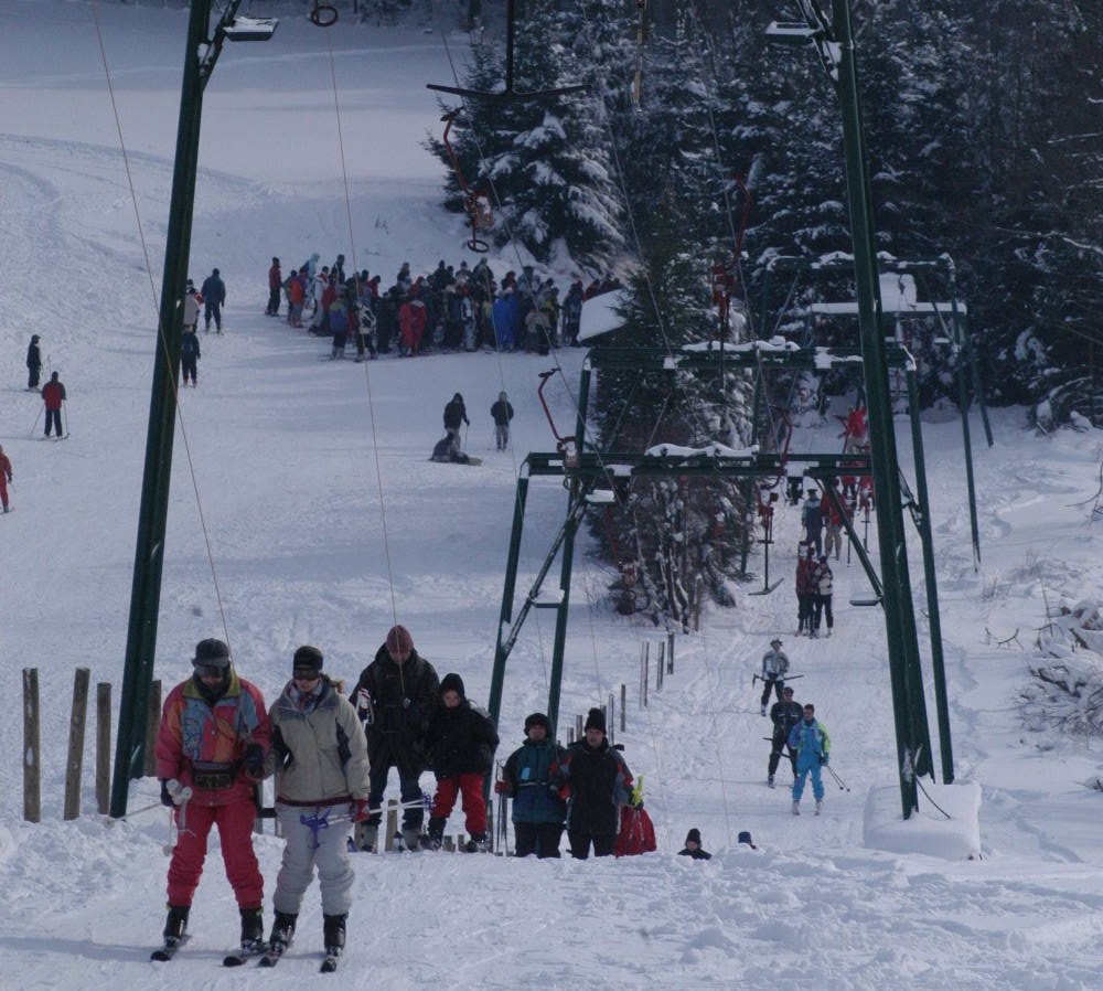 Weißer Stein – Hellenthal in Germany - a group of people skiing down a snowy hill.