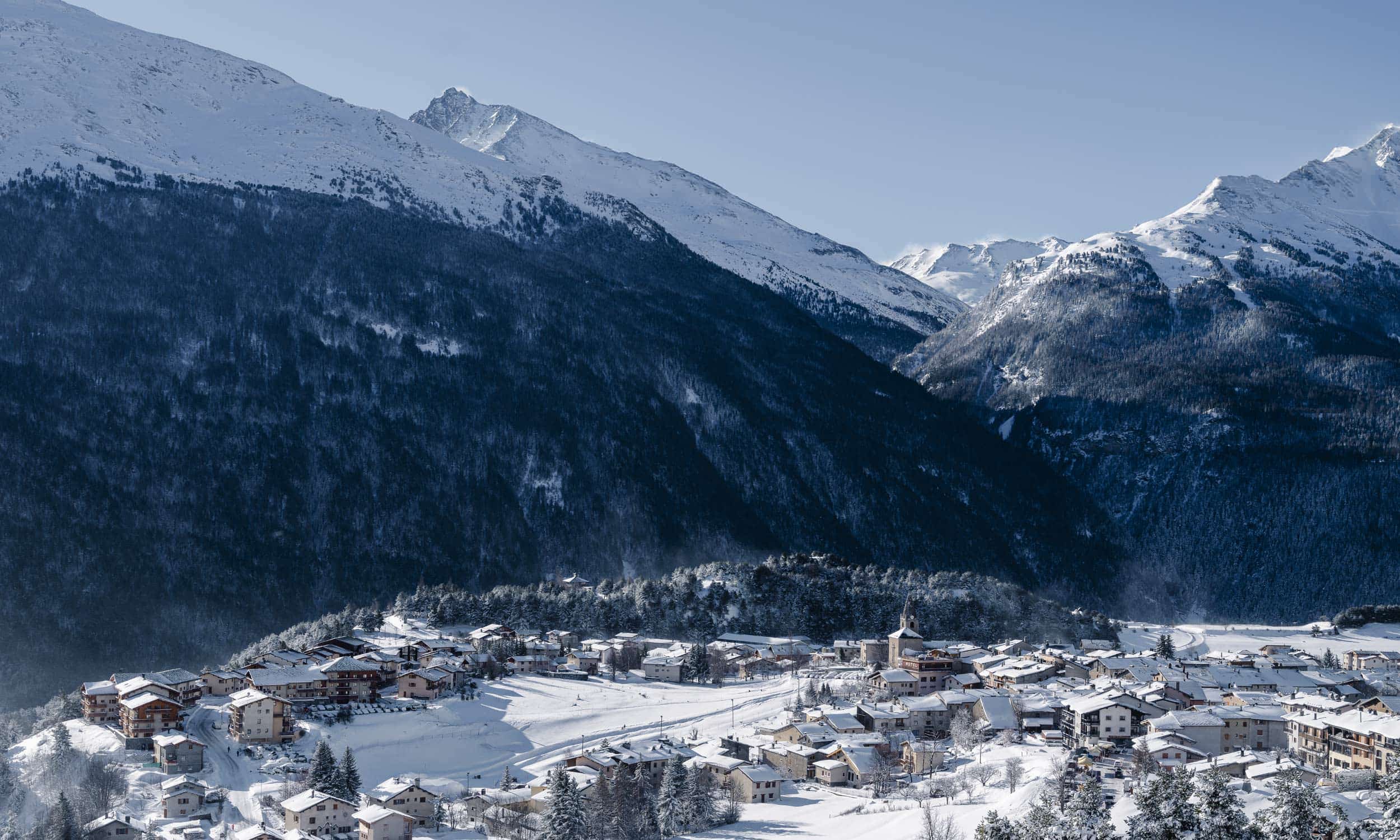 Winter sports scene at Aussois in Savoie Mont Blanc, Auvergne-Rhône-Alpes, France featuring a charming chalet amidst a stunning snowy landscape indicative of a ski resort.
