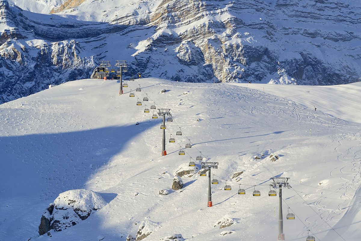 Shahdag Mountain Resort in Azerbaijan - a ski lift going up a snowy mountain.