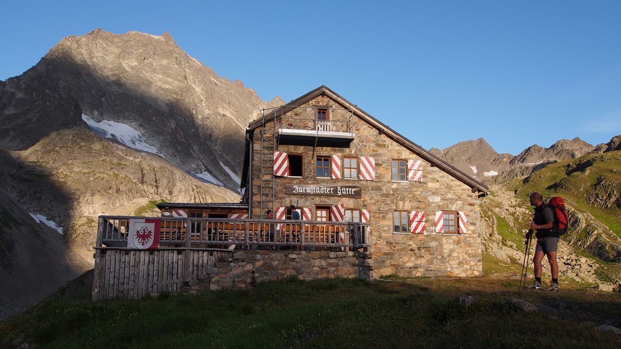 Darmstädter Hütte in Germany - a person standing in front of a mountain house.