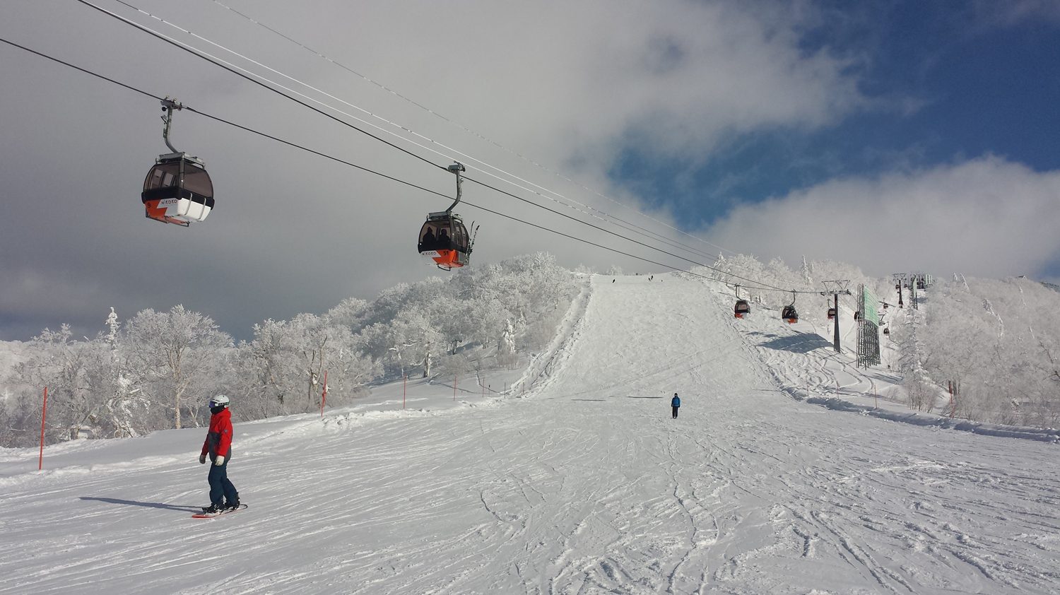 Kiroro in Japan - a person riding a ski board down a snowy slope.