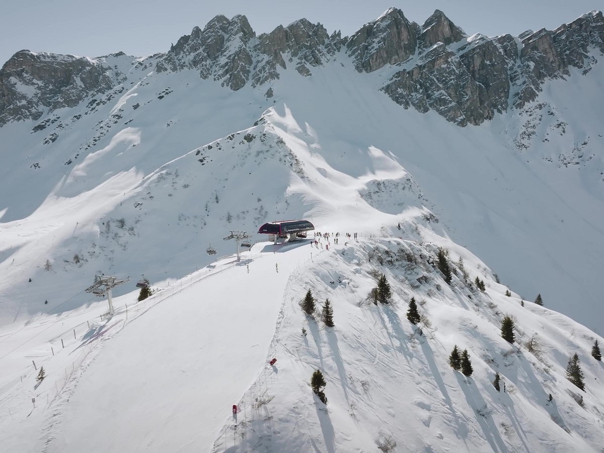 Ladurns in Italy - a group of people skiing down a snow covered mountain.