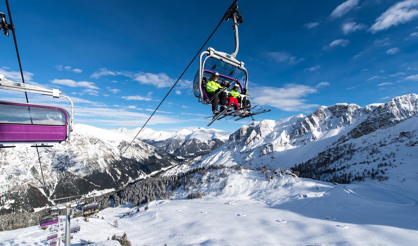 Ladurns in Italy - a person on a ski lift in the mountains.