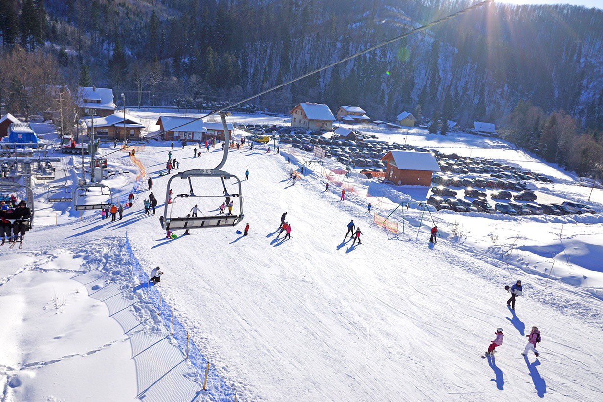 Polana Zielenska – Wisła in Poland - a ski slope with people skiing down it.
