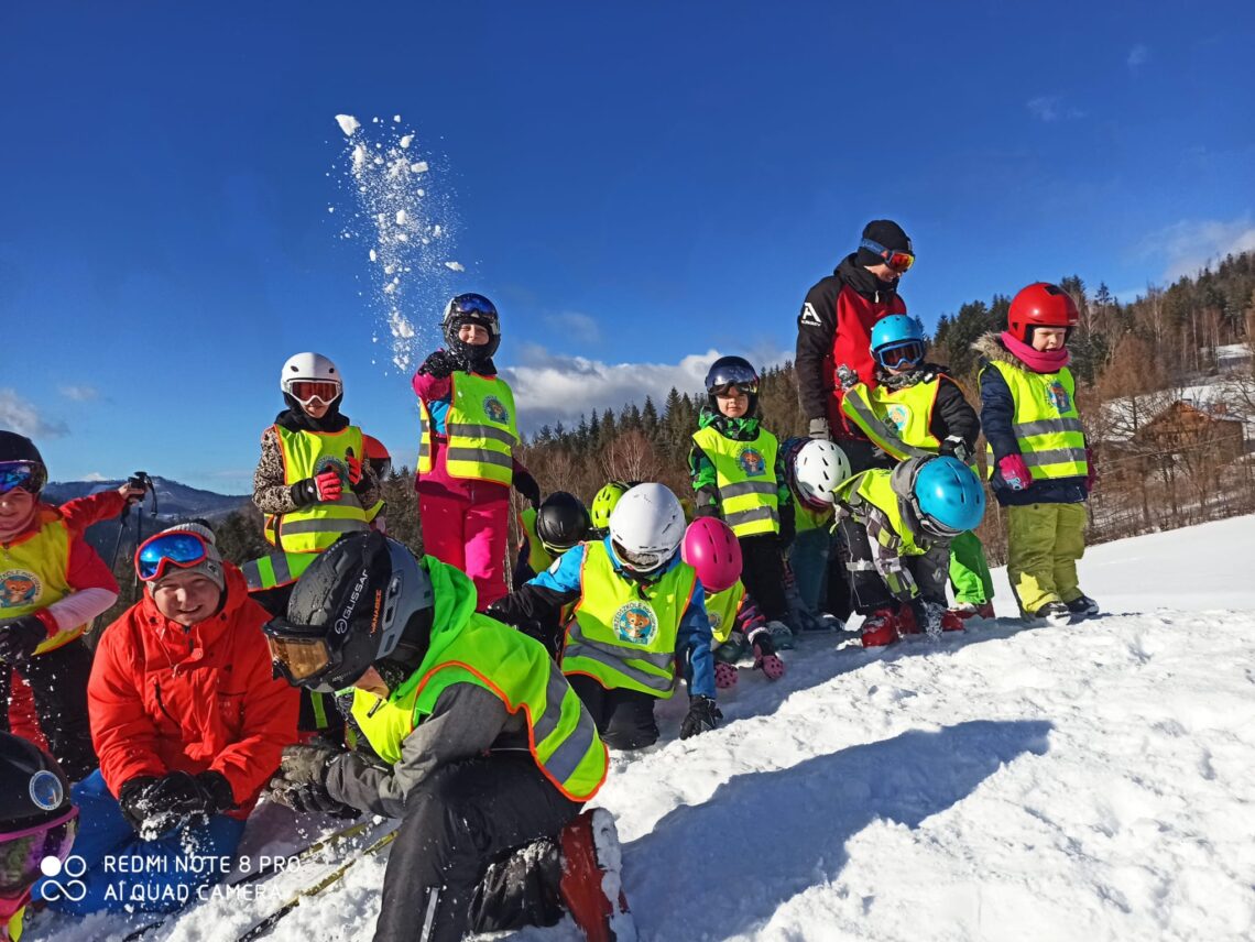 Polana Zielenska – Wisła in Poland - a group of people sitting on top of a snow covered hill.