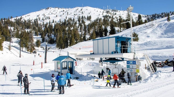 Bogus Basin in USA - a group of people standing on top of a ski slope.