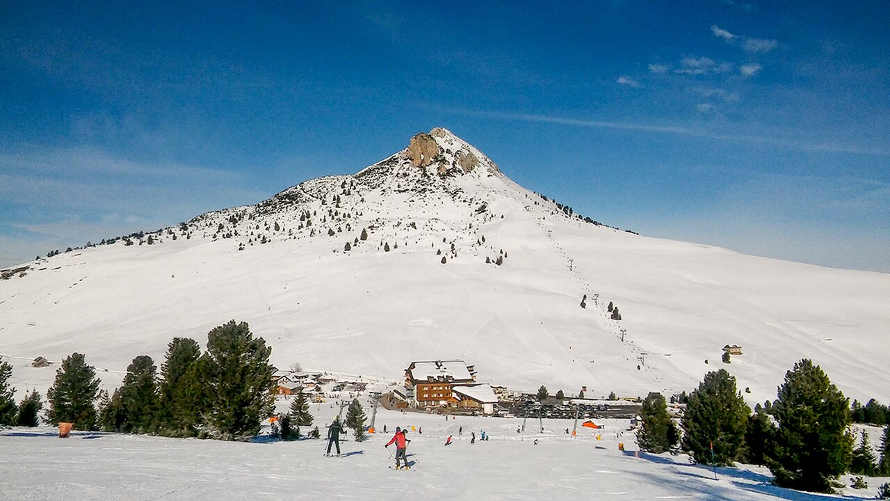 Jochgrimm in Italy - a group of people skiing down a snowy slope.