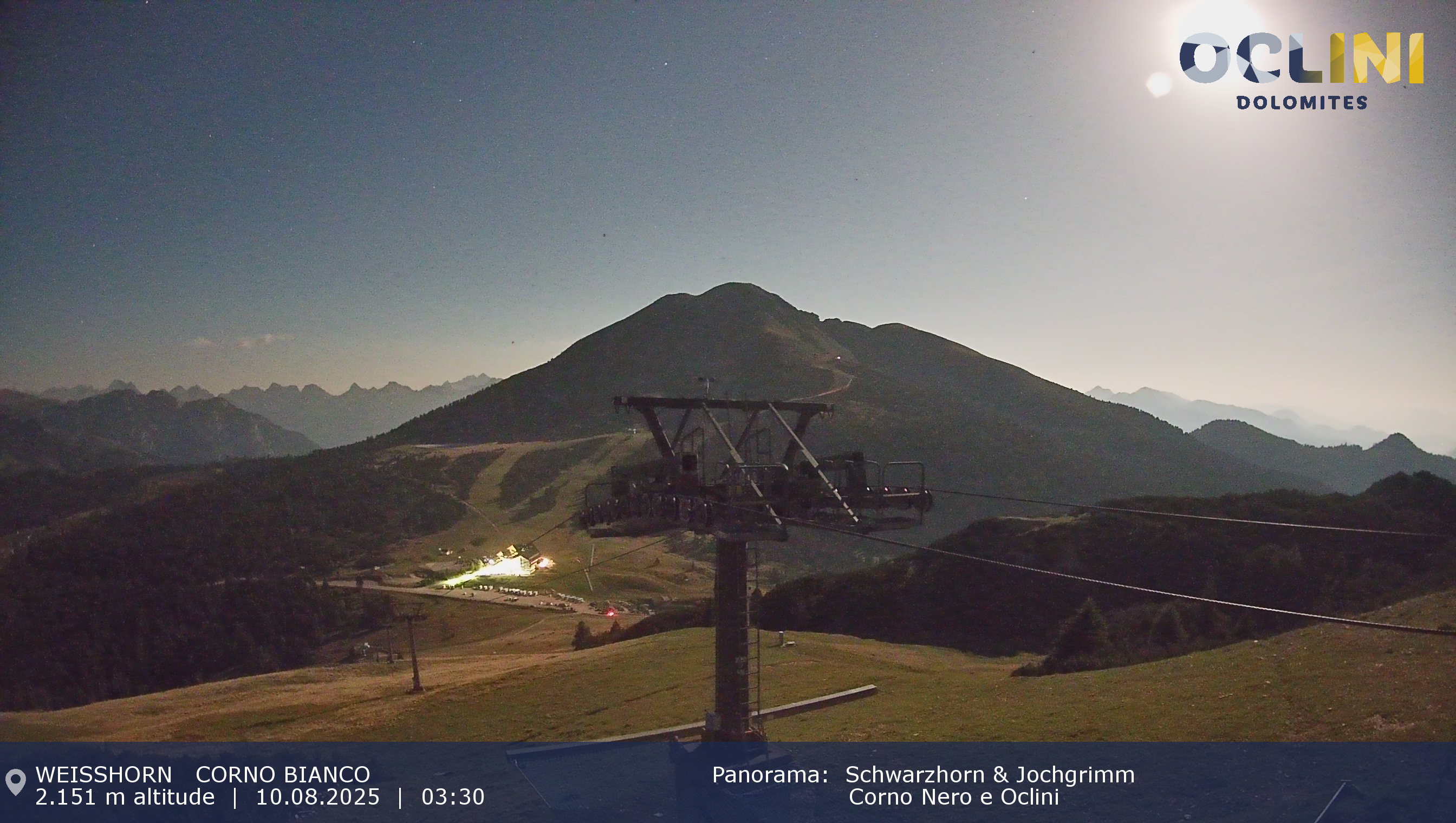 An scenic view of the Jochgrimm ski resort in Italy, capturing a lively winter sports scene. Snow-covered slopes and a ski lift accentuate the stunning winter scenery.