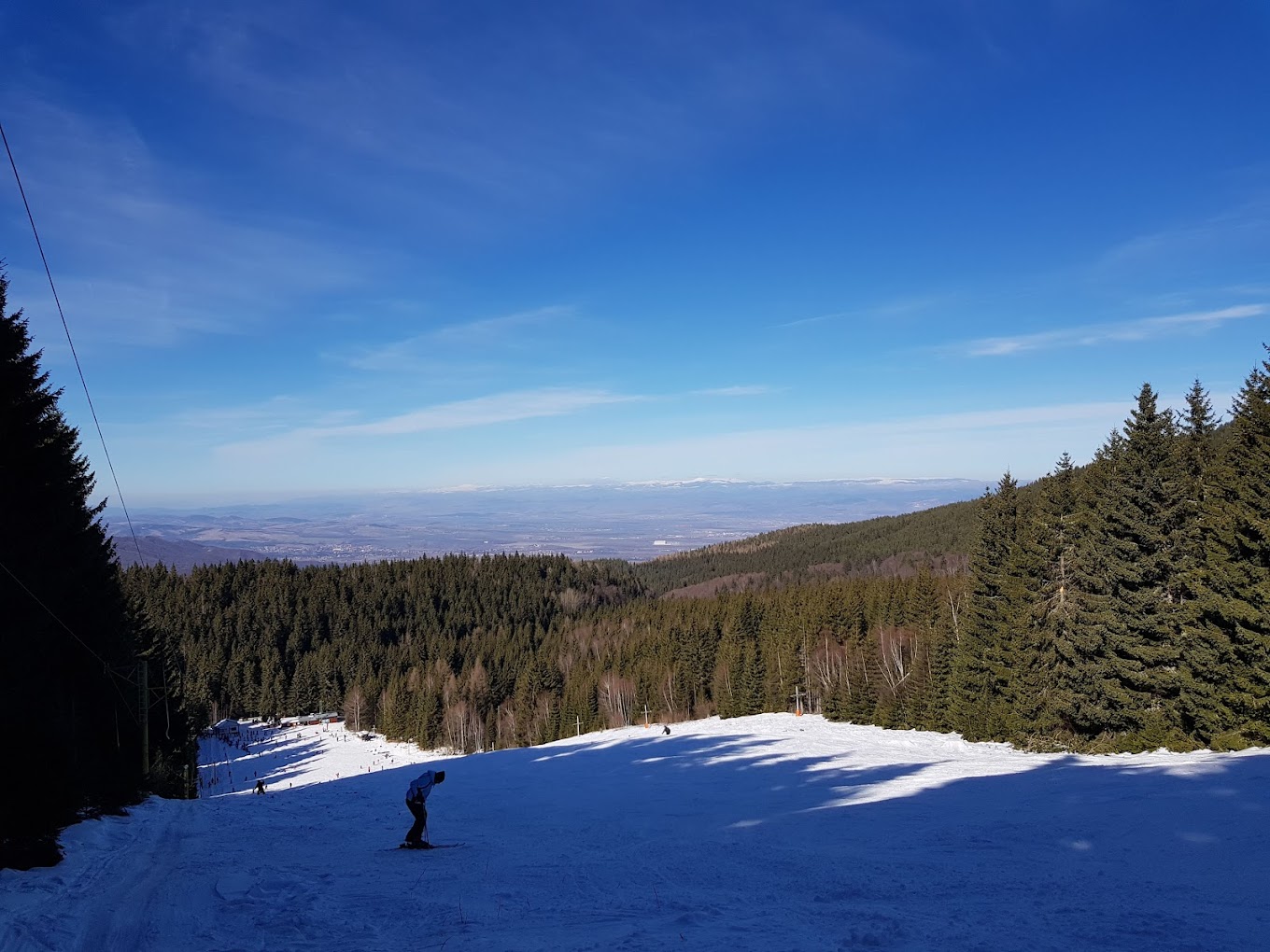 Vetrovala in Bulgaria - a person riding a snowboard down a snowy slope.