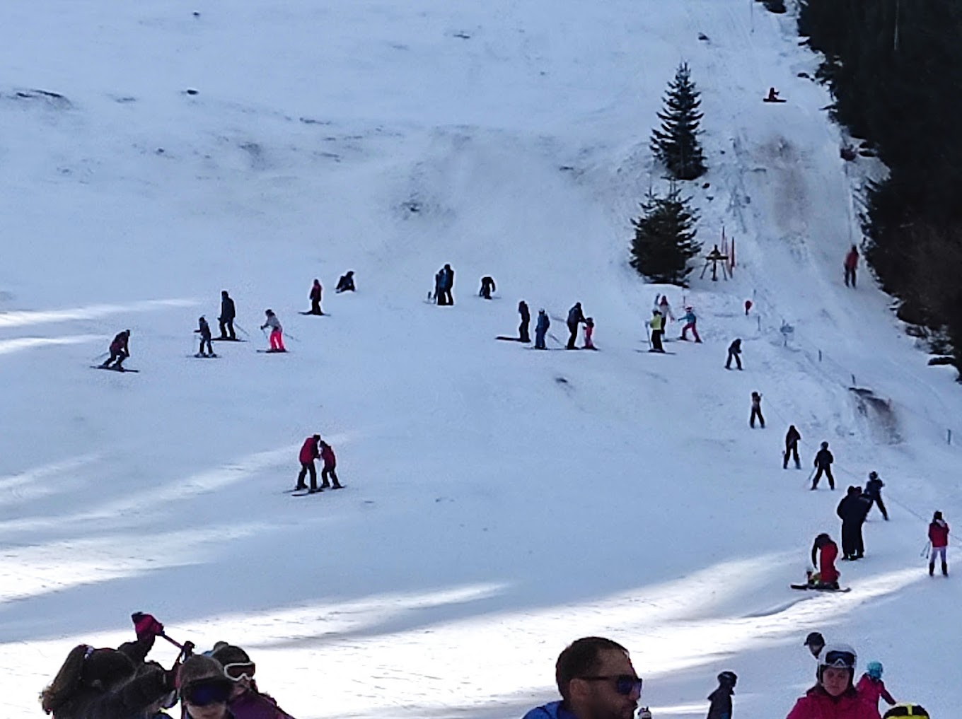 Vetrovala in Bulgaria - a group of people skiing down a snowy hill.