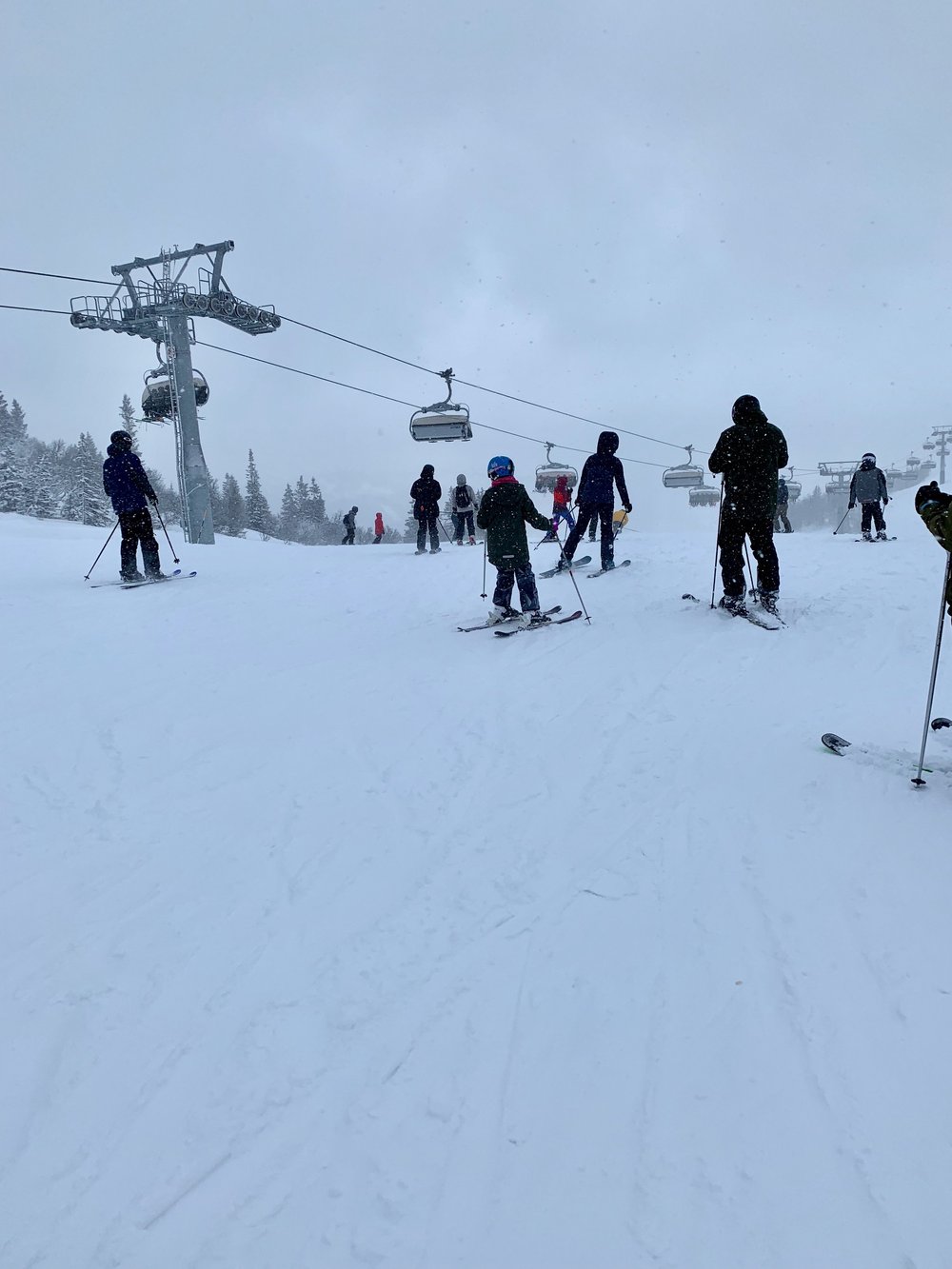 Ounasvaara – Rovaniemi in Finland - a group of people skiing down a snow covered slope.