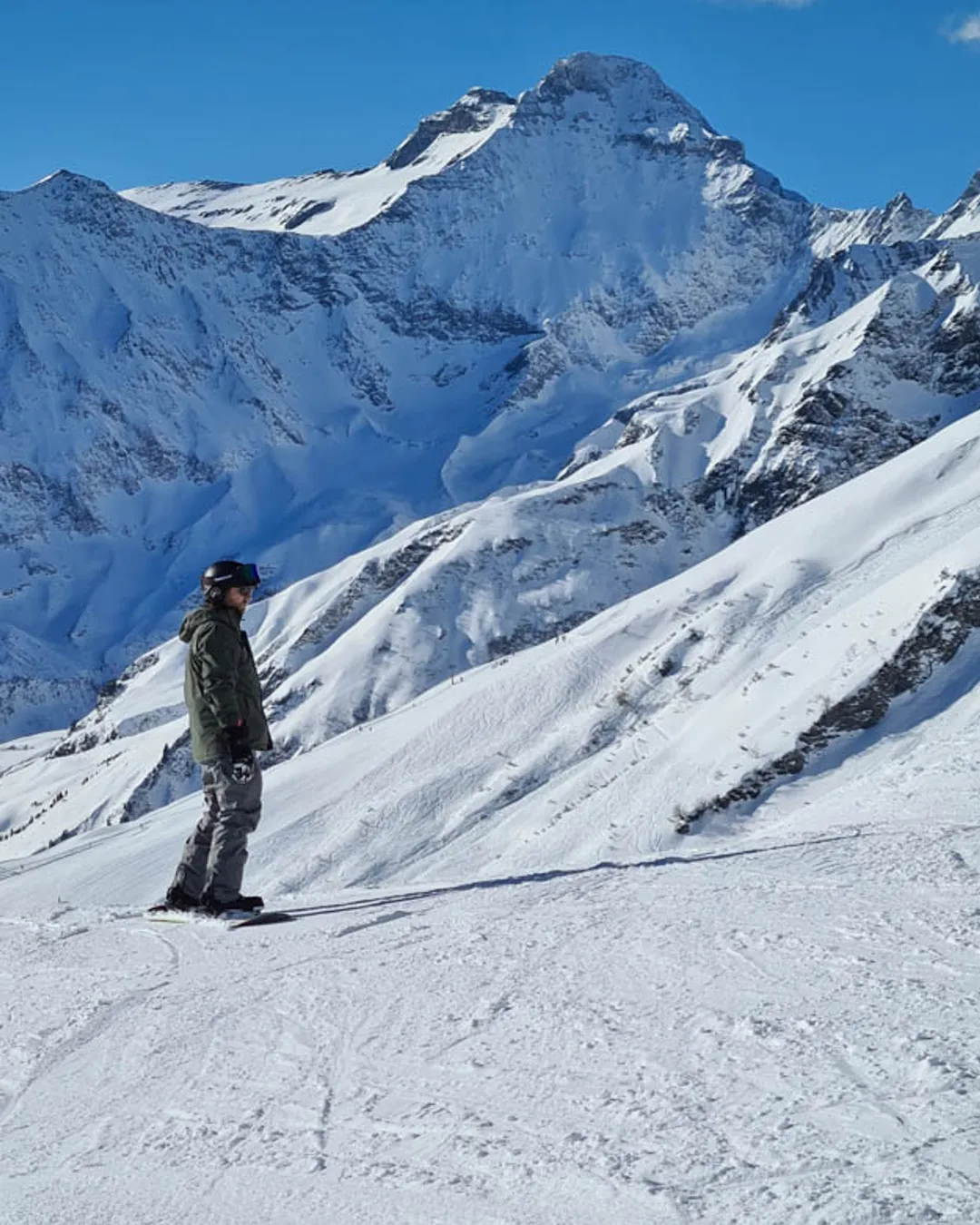 Elm in Switzerland - a person on a snowboard in the snow.