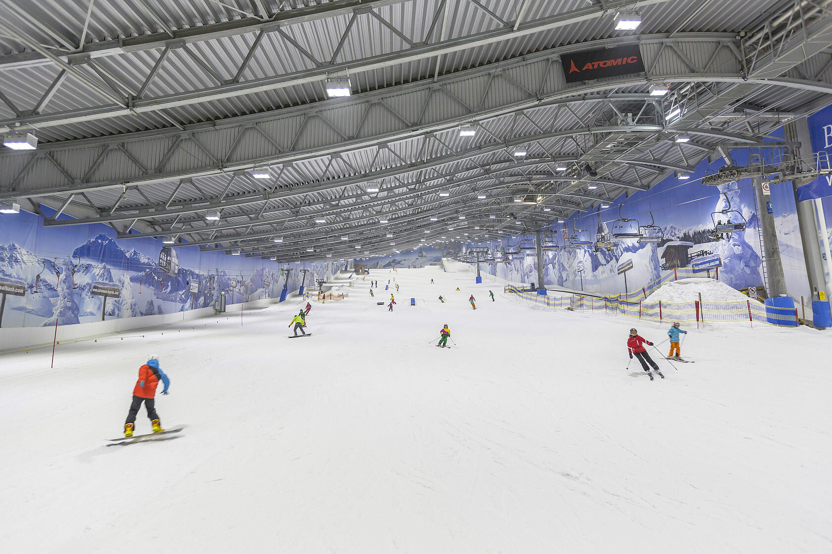 Alpenpark Neuss in Germany - a group of people riding ski boards down a slope.