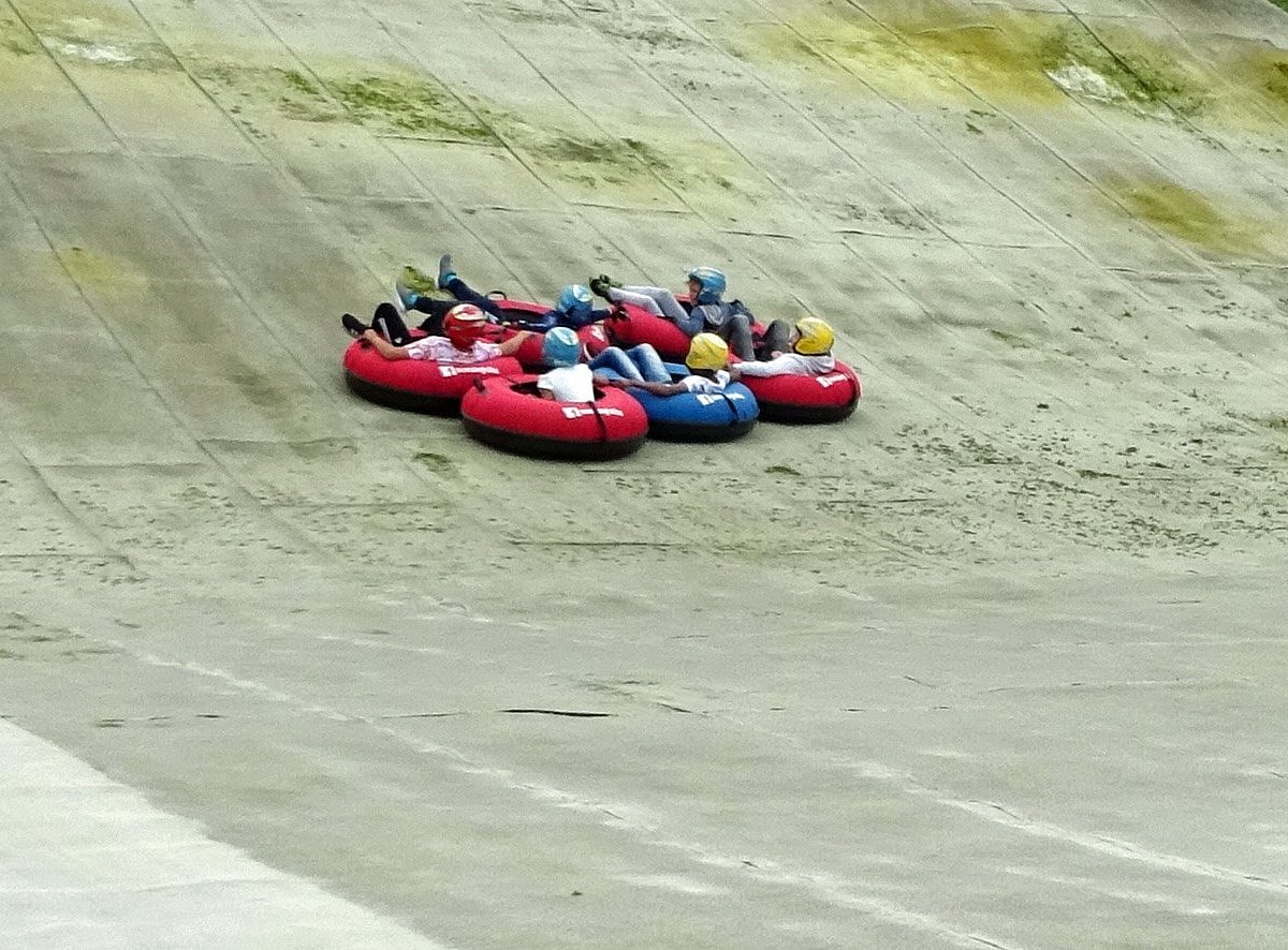 Halifax Ski Centre in United Kingdom - two people are tubling down a hill.