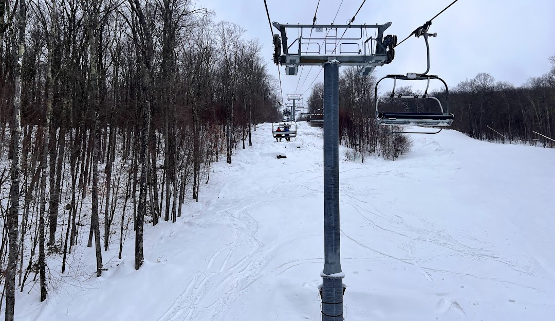 Gore Mountain in USA - a ski lift going down a snowy slope.