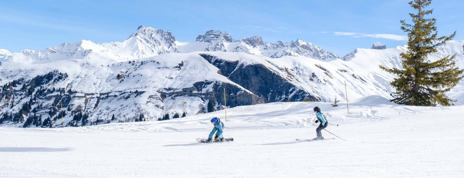 Arêches in France - two people skiing down a snow covered mountain.