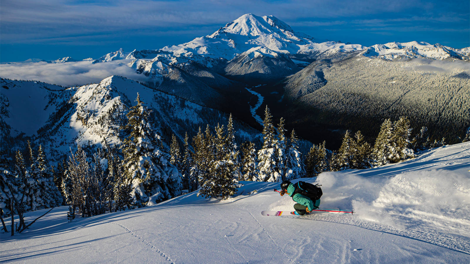 Crystal Mountain -WA in USA - a person riding a snowboard down a snowy slope.