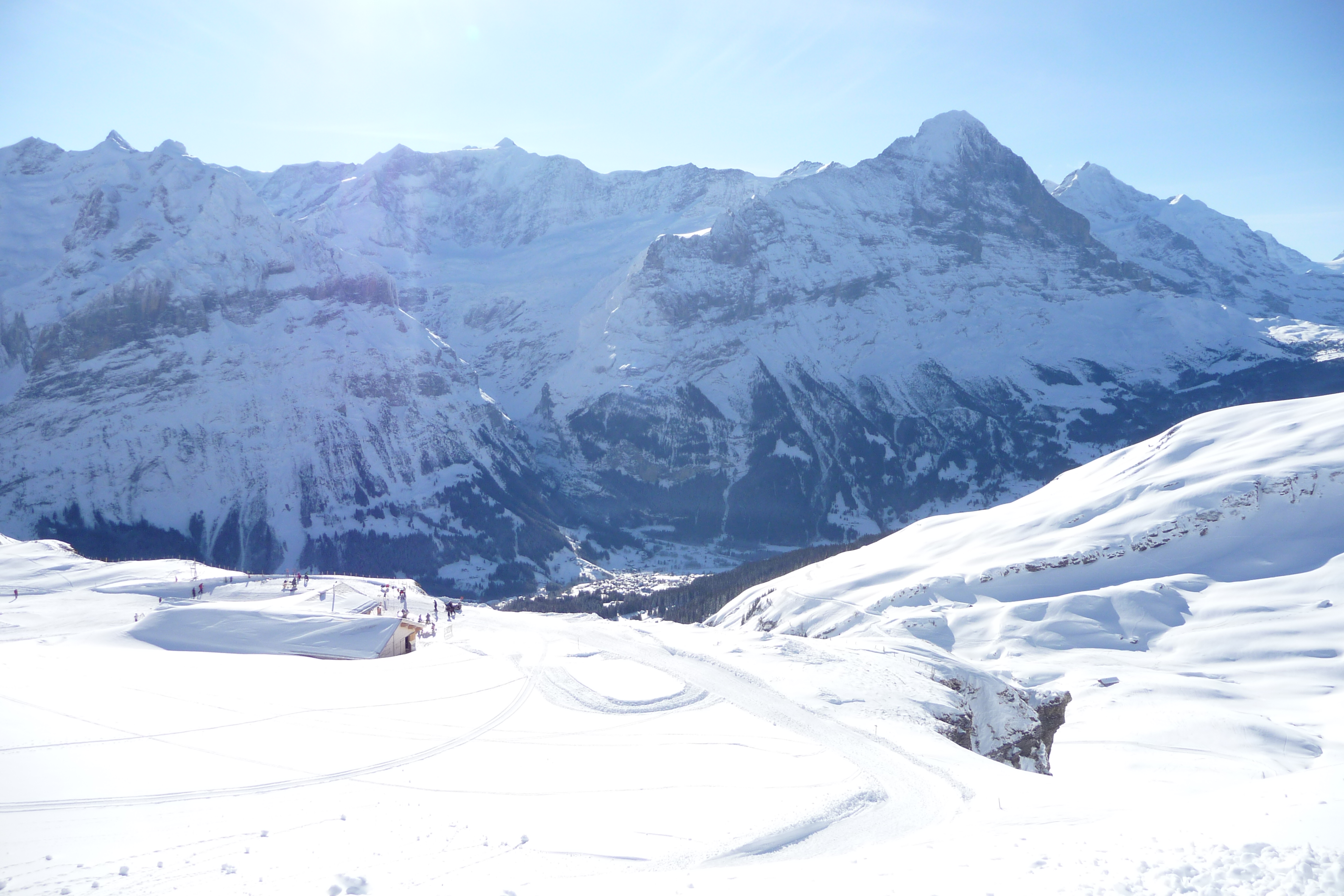 Grindelwald First in Switzerland - a group of people skiing down a snowy mountain.