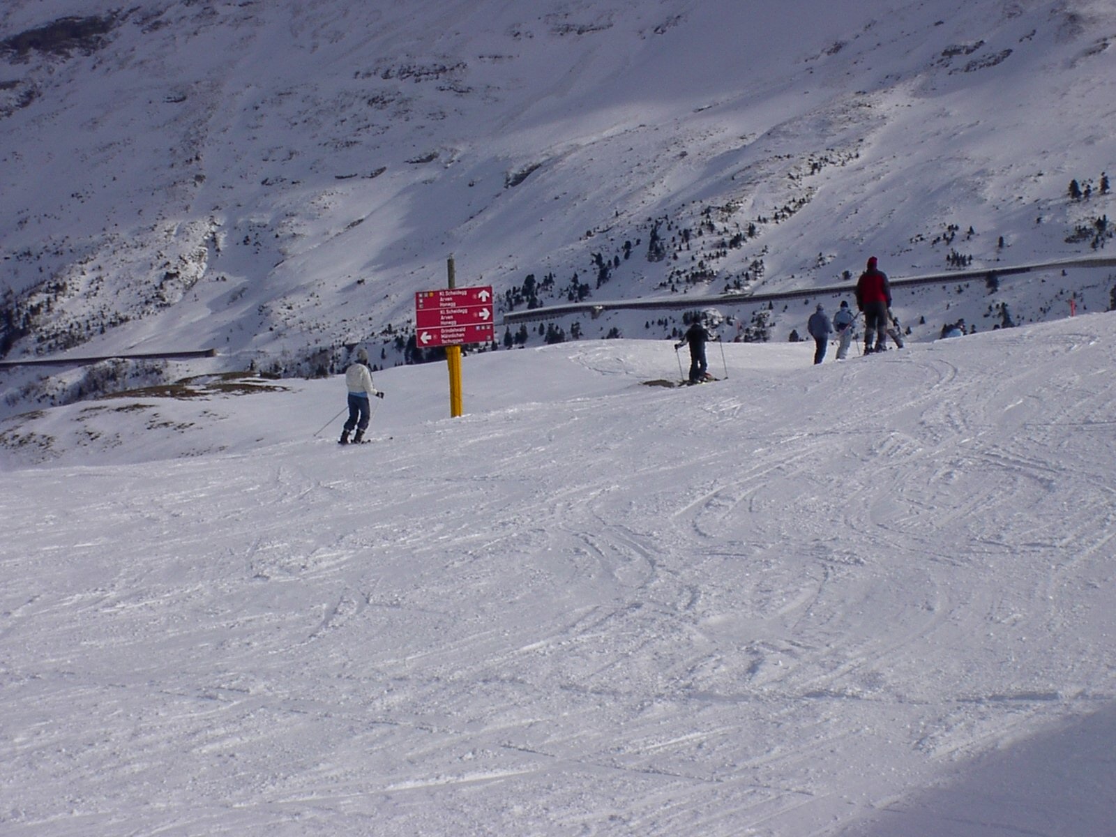 Grindelwald First in Switzerland - a group of people skiing down a snowy slope.