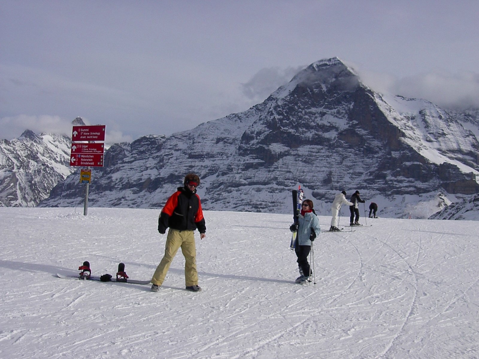 Grindelwald First in Switzerland - a group of people skiing down a mountain.