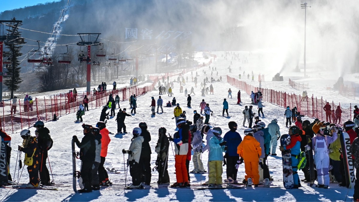 Beidahu Jilin in China - a group of people standing on top of a ski slope.