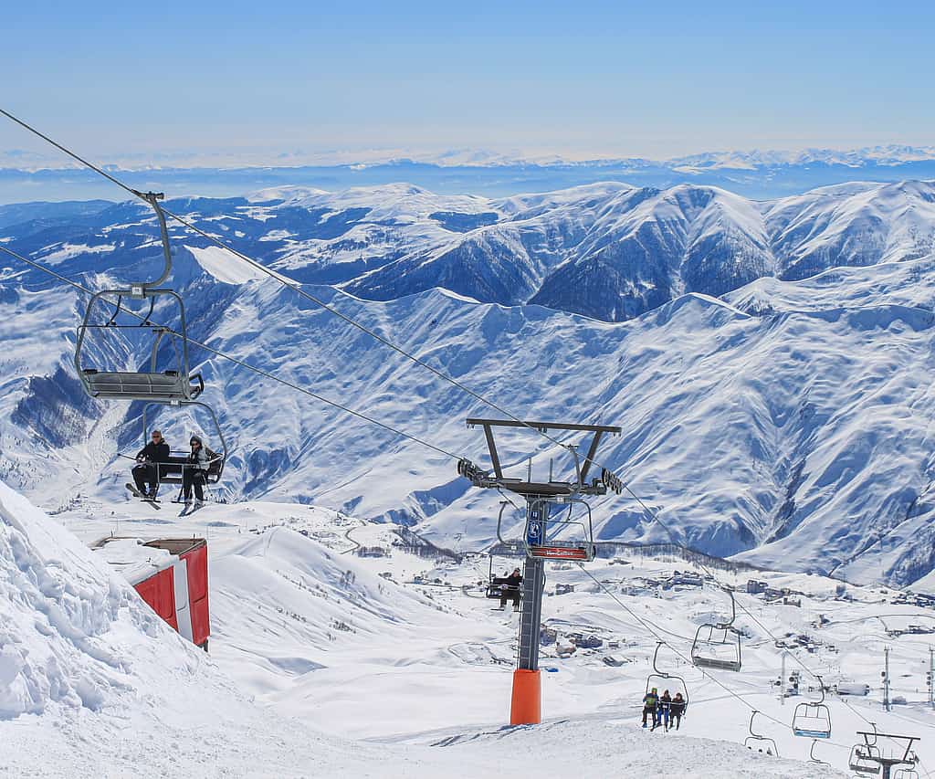 Gudauri in Georgia - a ski lift going up a snowy mountain.