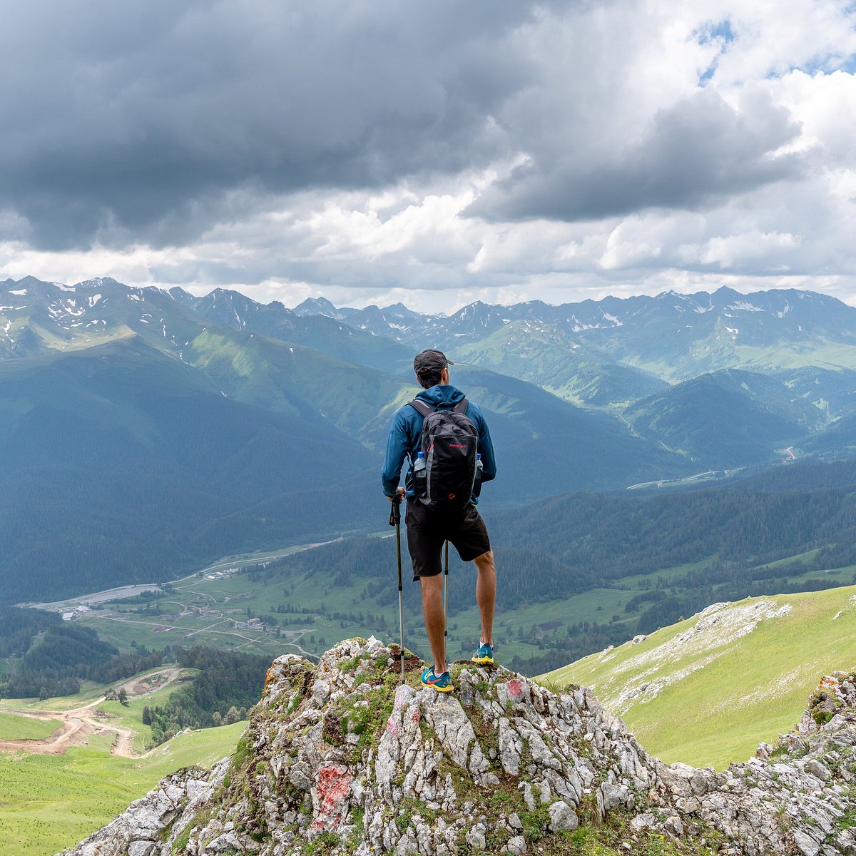 Kurort Arkhyz in Russia - a man standing on top of a mountain.