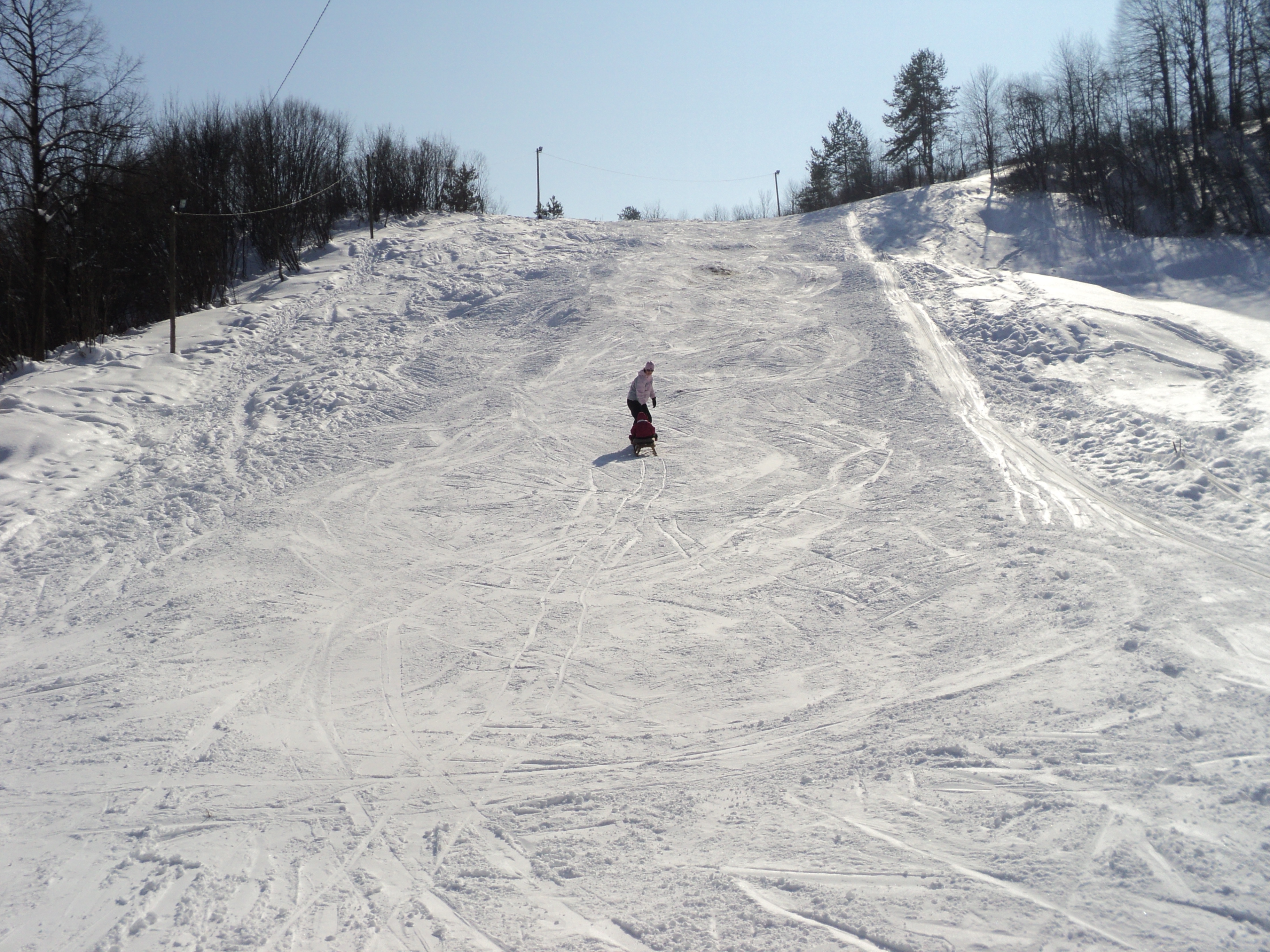 Vučići in Croatia - a person riding a snowboard down a hill.