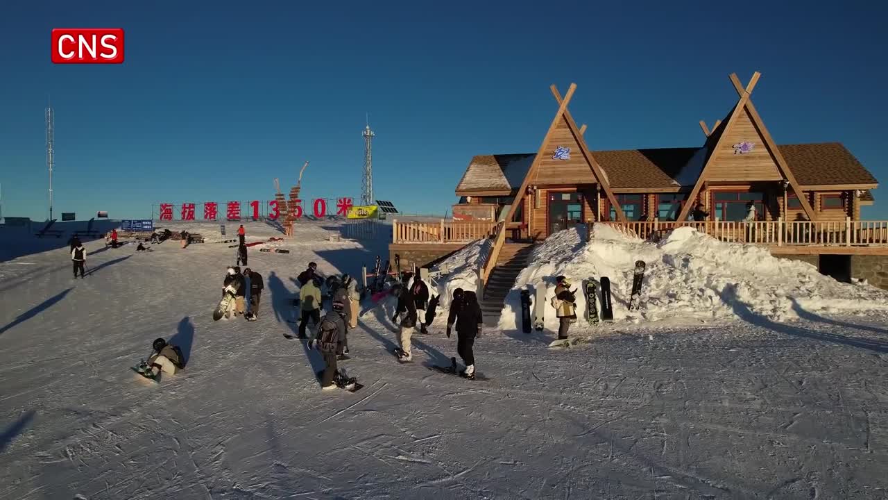 Koktokay in China - a group of people standing on top of a snow covered hill.
