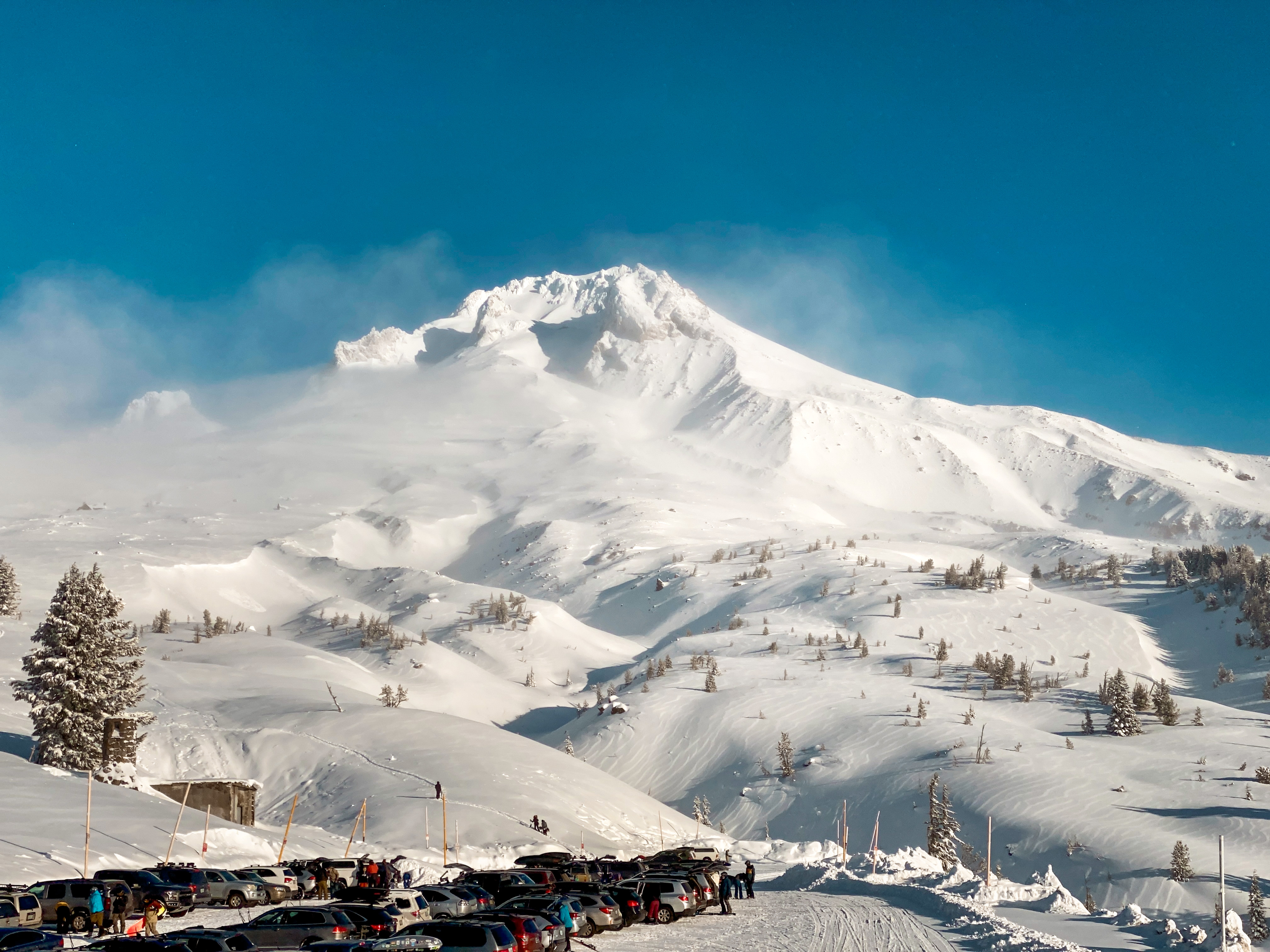 Timberline in USA - a group of people standing on a snow covered mountain.