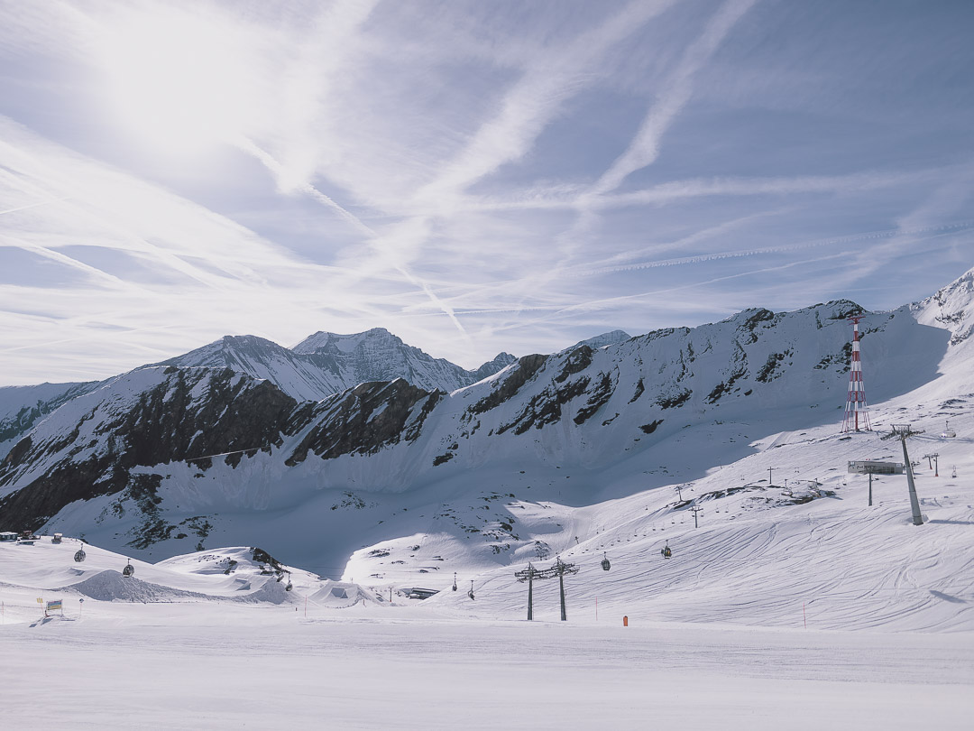 Kitzsteinhorn in Austria - a group of people skiing down a snowy mountain.