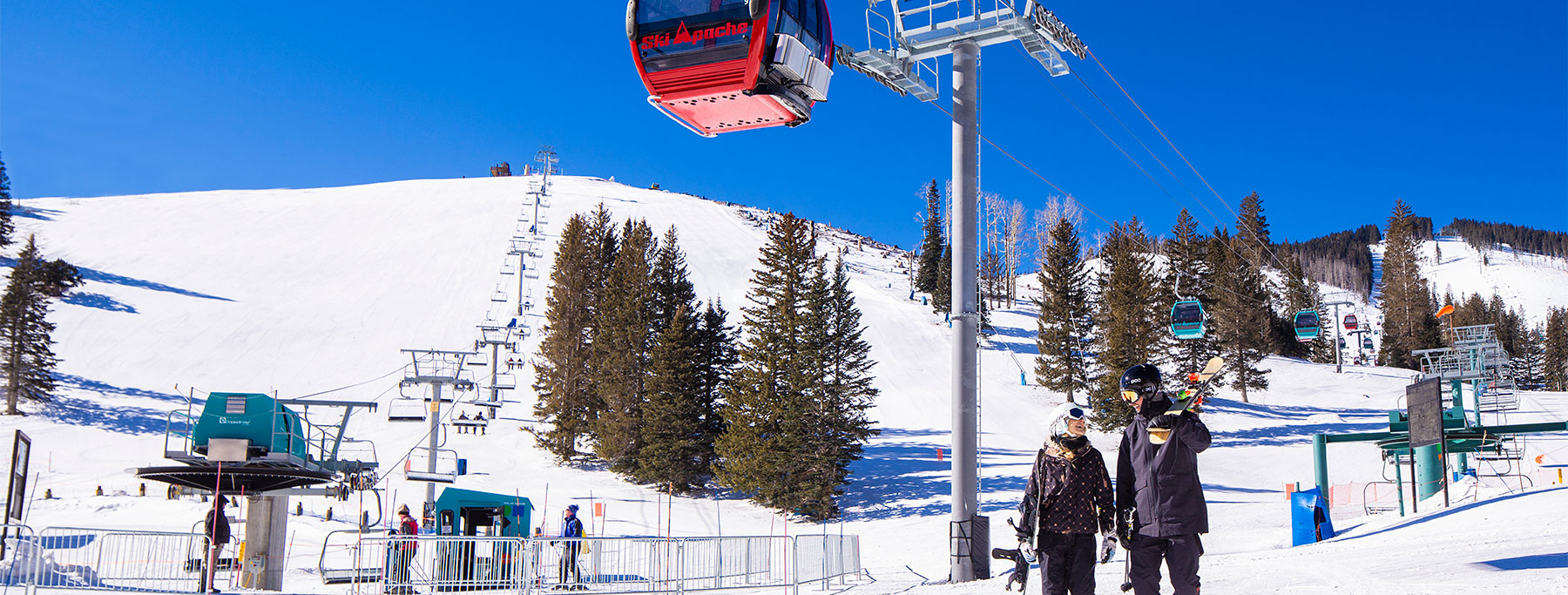Ski Apache in USA - a man riding a ski lift in the snow.