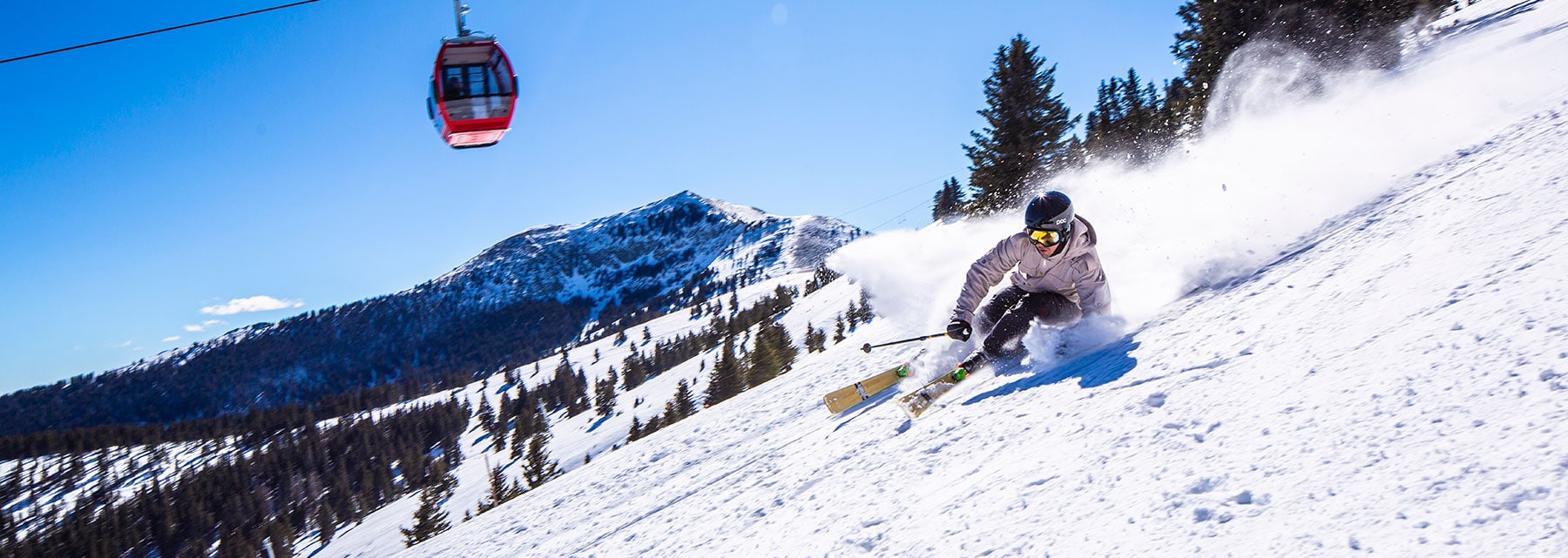 Ski Apache in USA - a person skiing down a snowy slope on a ski board.