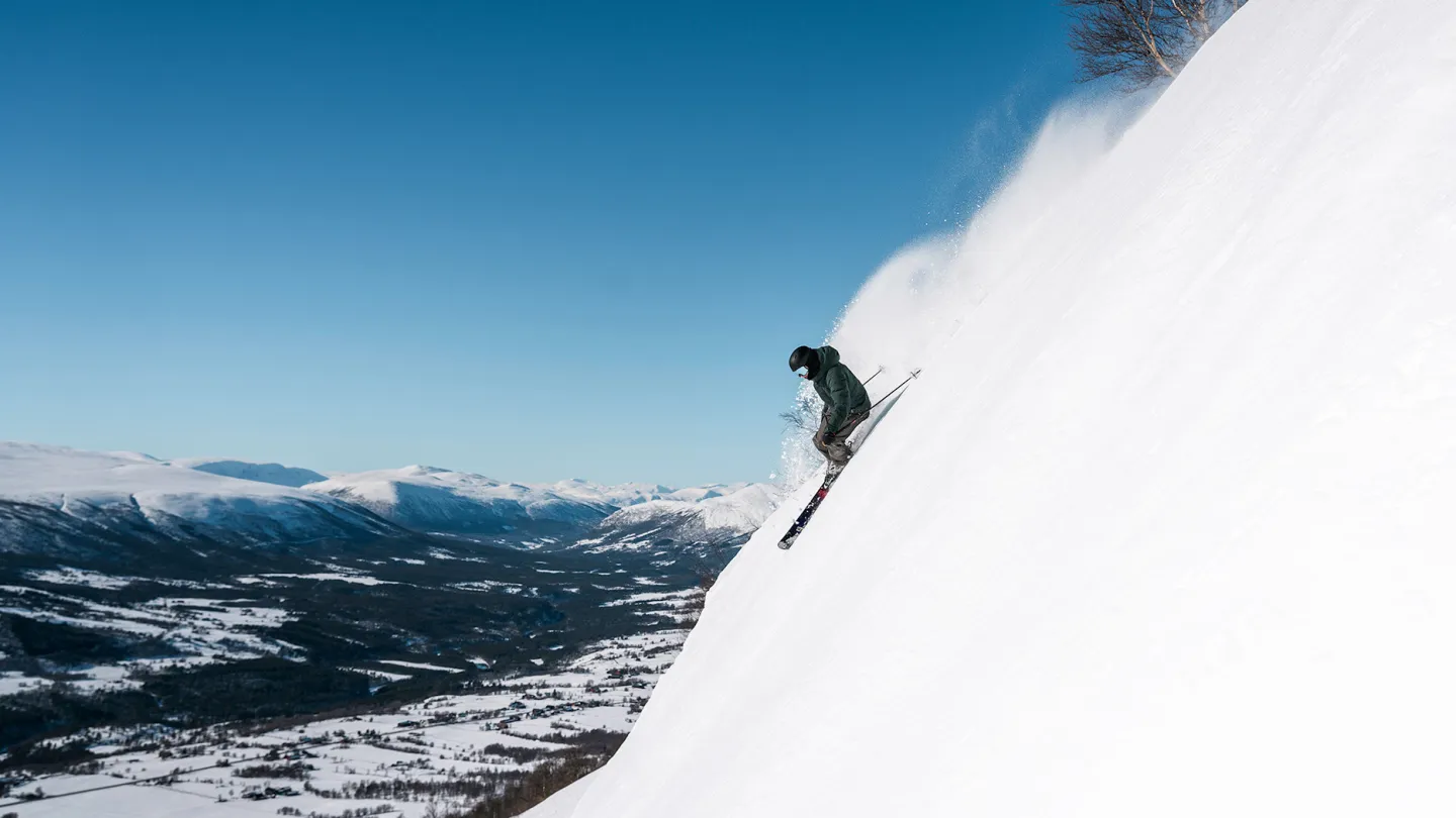 Oppdal in Norway - a person skiing down the side of a mountain.