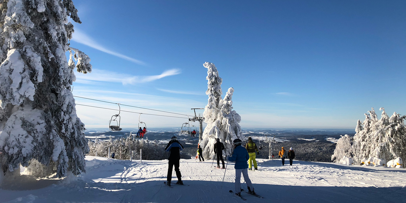 Mitterdorf Skizentrum in Germany - a group of people skiing down a snowy slope.