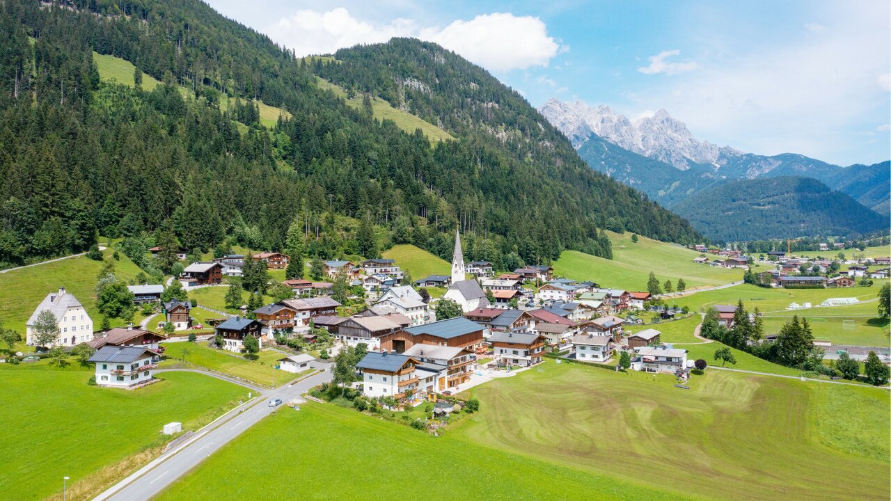 Buchensteinwand – St Ulrich am Pillersee | ​St Jakob in Haus | ​Hochfilzen in Austria - an aerial view of a village in the swiss alps.