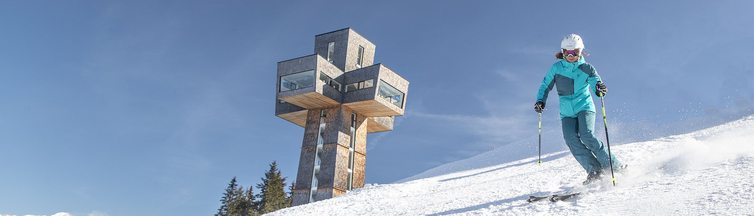 Buchensteinwand – St Ulrich am Pillersee | St Jakob in Haus | Hochfilzen in Austria - a person on skis going down a hill.