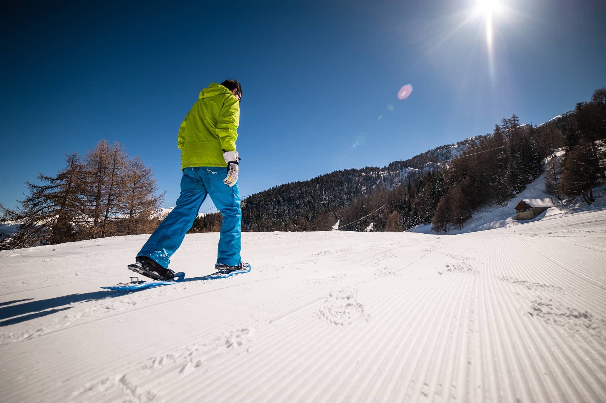 A snowboarder showcasing their skills on the snow-laden slopes of Karellis in Savoie Mont Blanc Montricher-Albanne situated in the scenic Auvergne-Rhône-Alpes region of France.