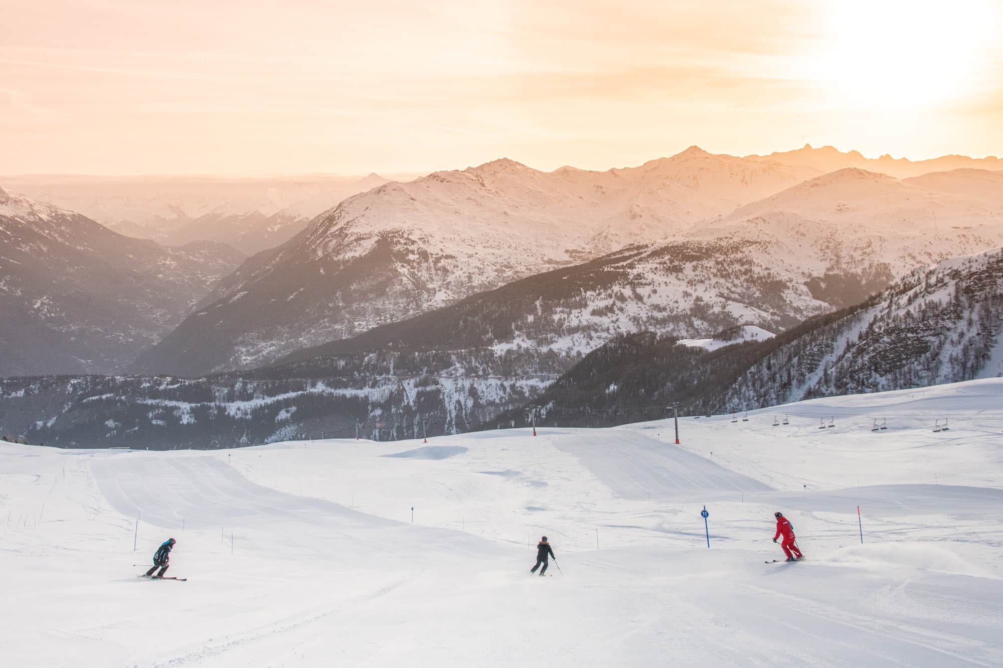 Winter sports scene at the ski resort in Karellis, Savoie Mont Blanc, featuring a skier and stunning winter scenery.