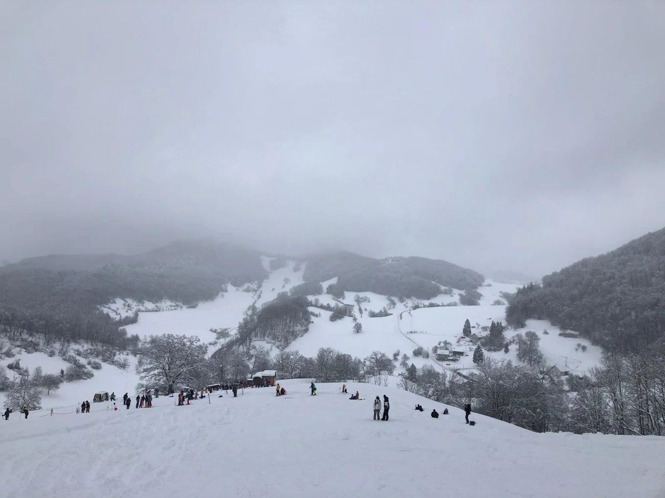 Winter sports scene set at a ski resort in Asp, Aargau. Pristine snow-covered slopes unfold against a stunning mountain backdrop in Northwestern Switzerland.