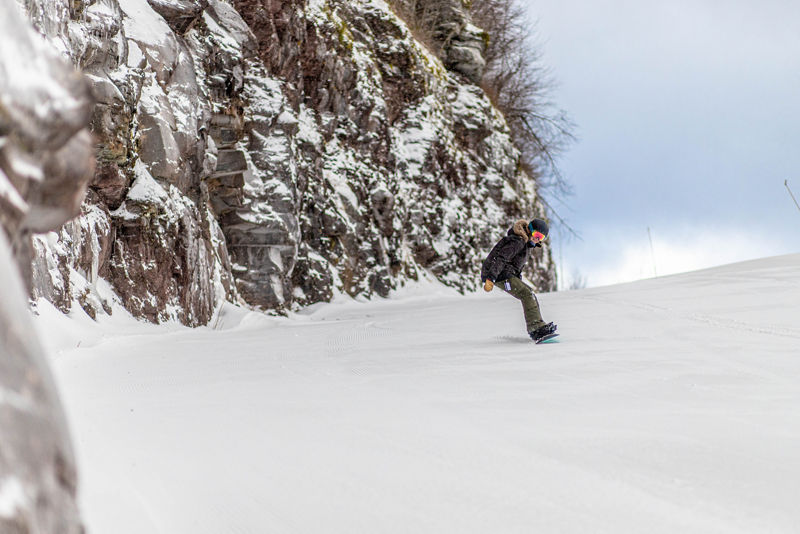 Hunter Mountain in USA - a person skiing down a snow covered mountain.