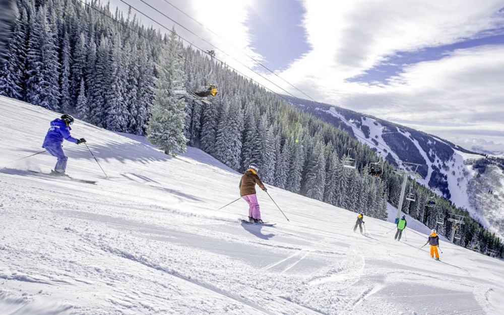 Hunter Mountain in USA - a group of people skiing down a snow covered slope.