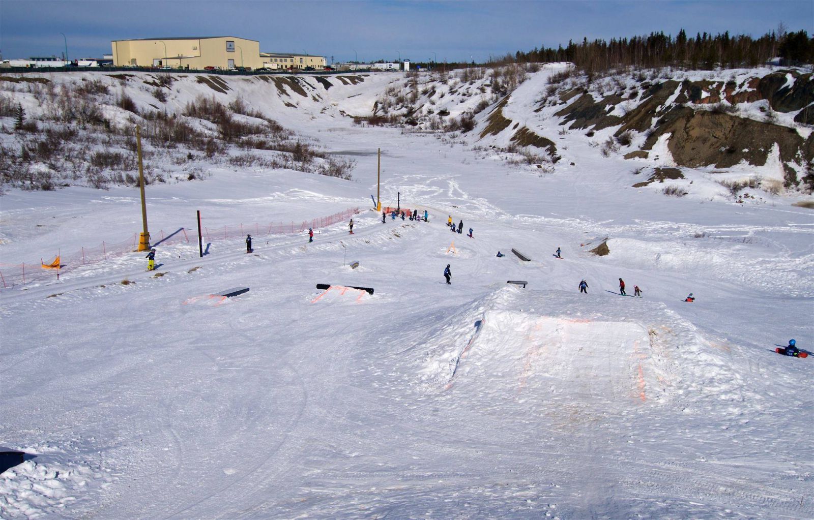 Bristol Pit – Yellowknife in Canada - a group of people skiing down a hill.
