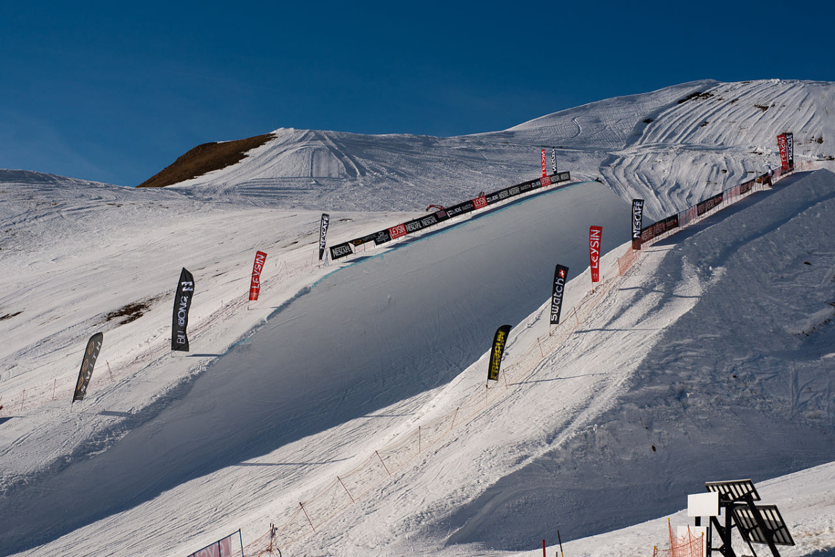 Leysin in Switzerland - a group of people riding down a snow covered slope.