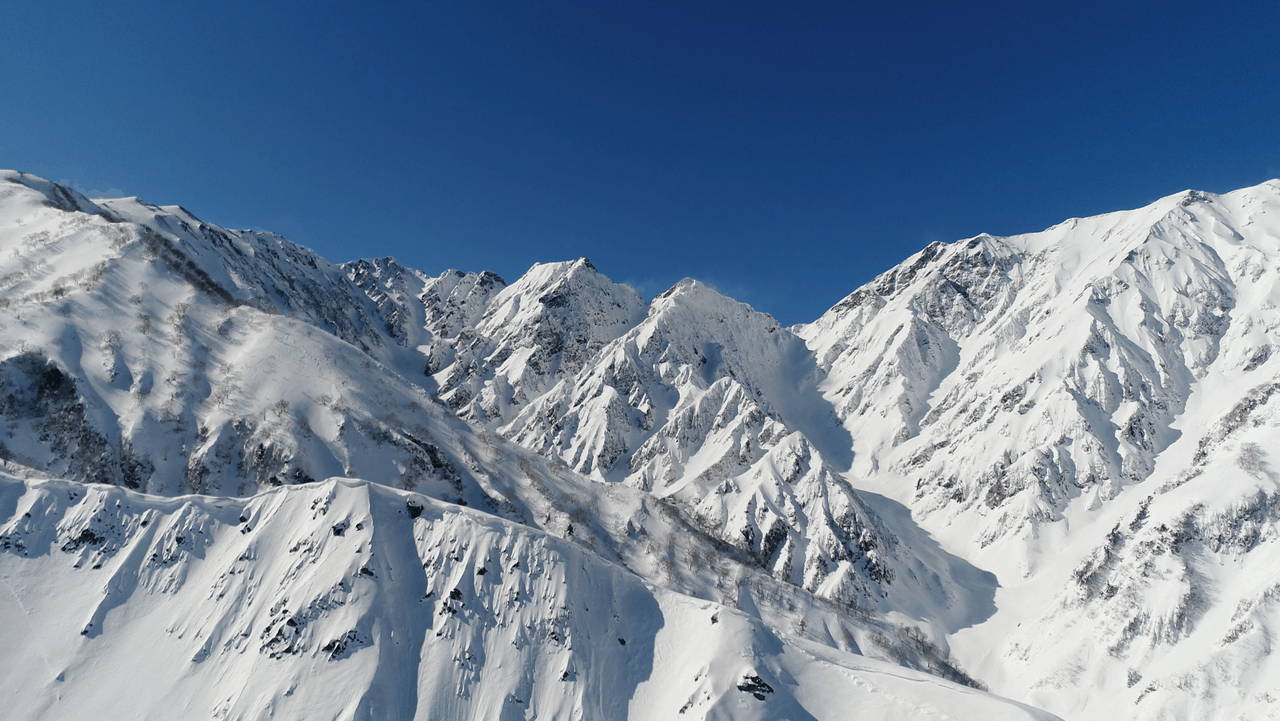 Hakuba Happo-One Snow Resort in Japan - a person skiing down a snow covered mountain.