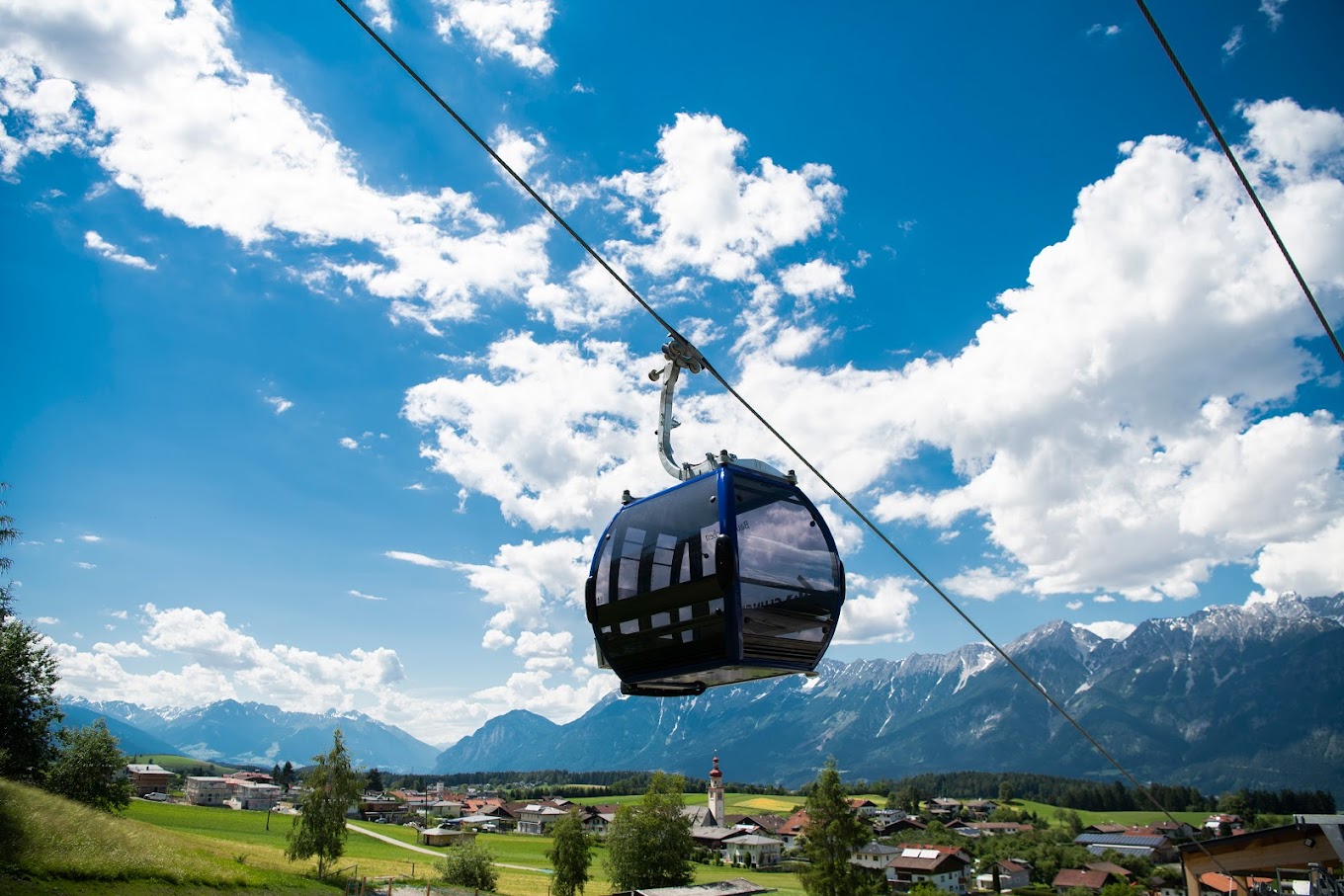 Glungezerbahn in Austria - a cable car in the mountains above a small town.