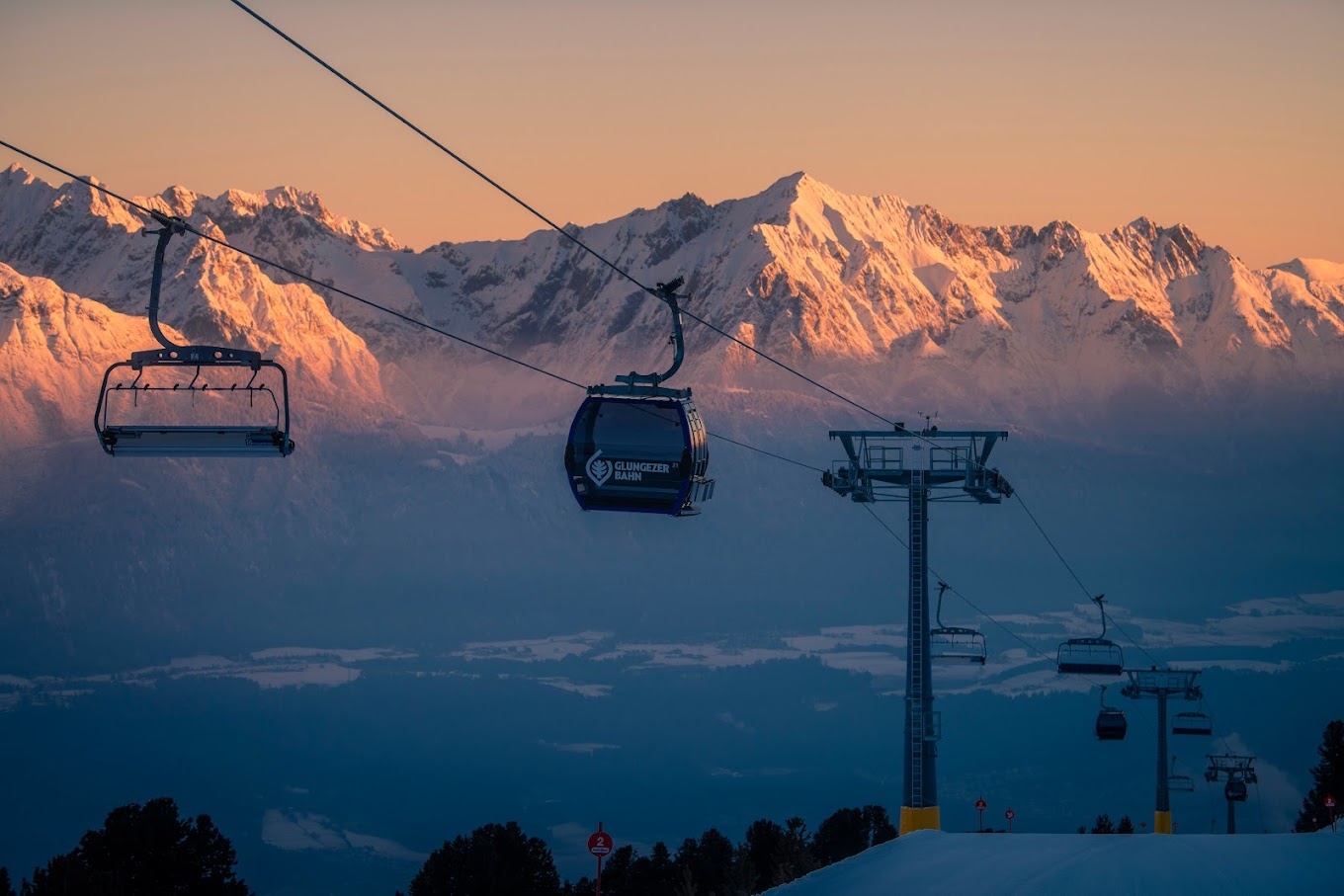Glungezerbahn in Austria - a ski lift going up to the top of a mountain.